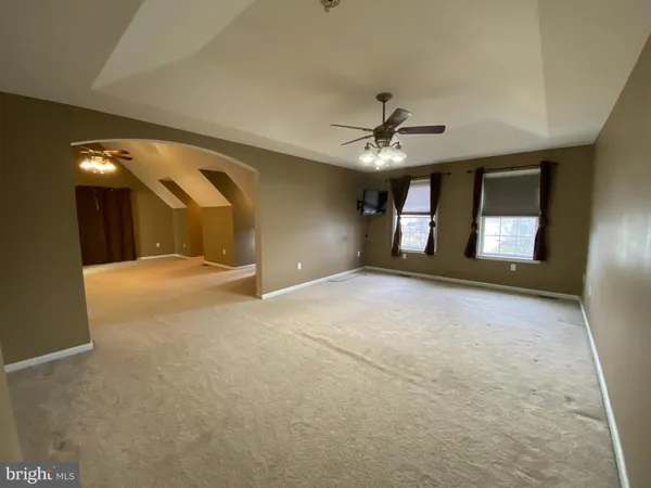 a view of a livingroom with a ceiling fan and window