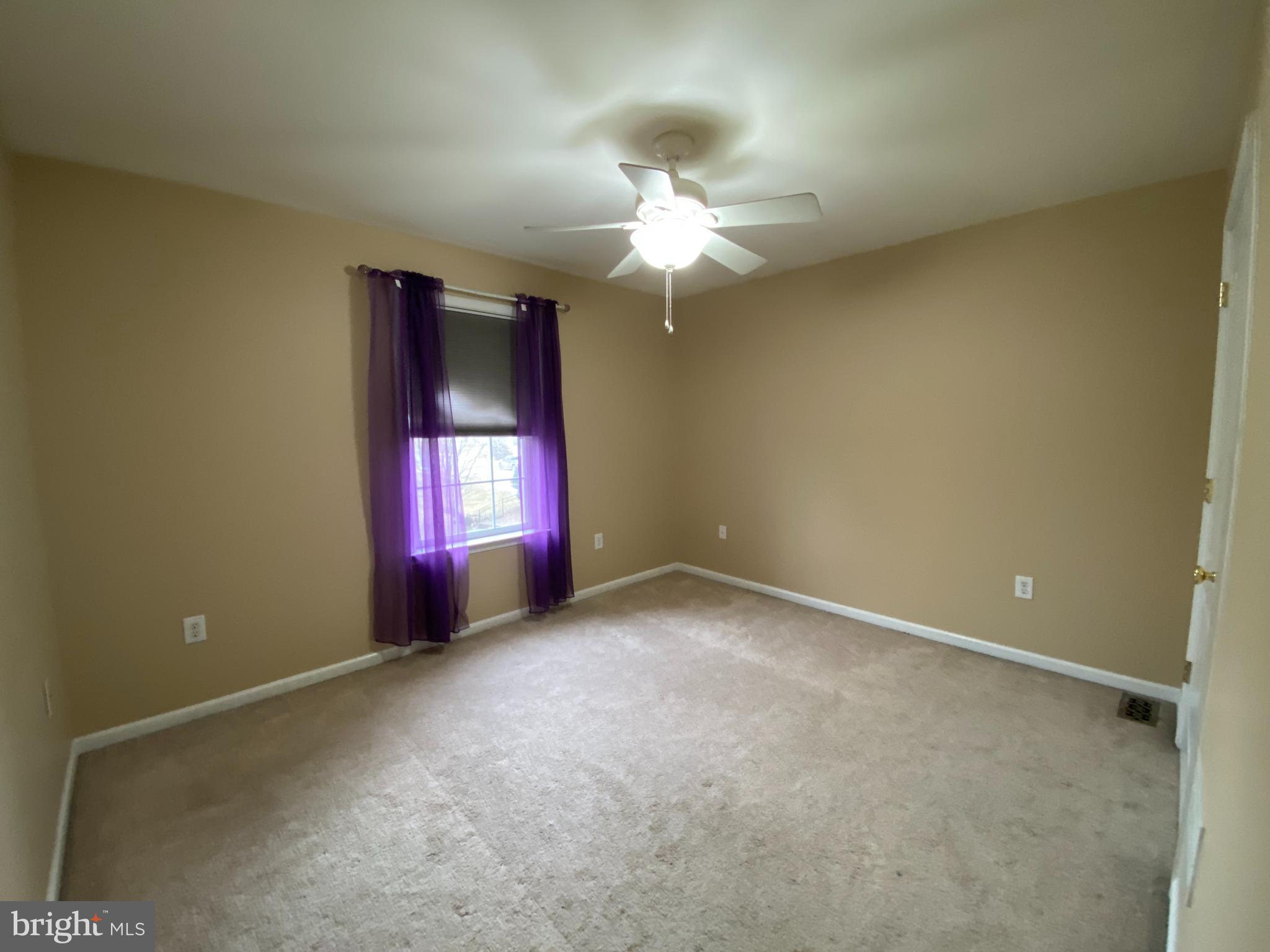 145 Long View Carlisle, PA 17013 - Photo 18 of 27 an empty room with a chandelier fan and windows