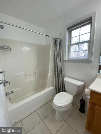 a bathroom with a toilet and a bathtub