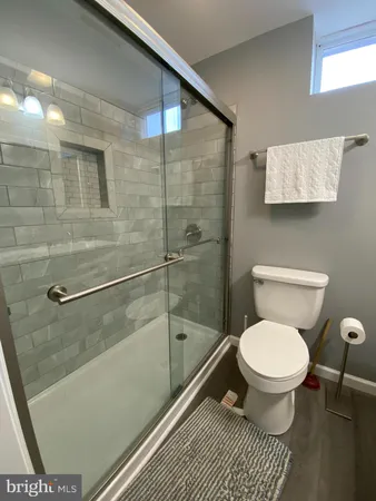 a bathroom with a toilet and a shower