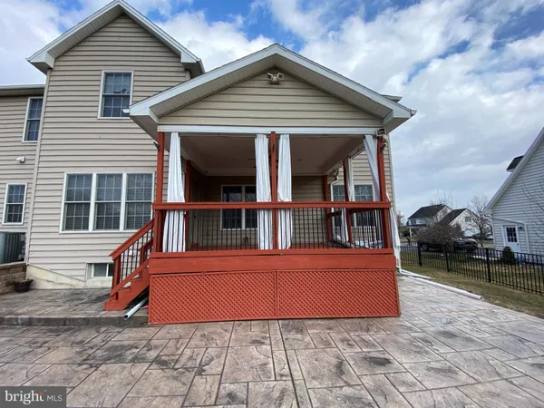 a view of a house with a wooden deck