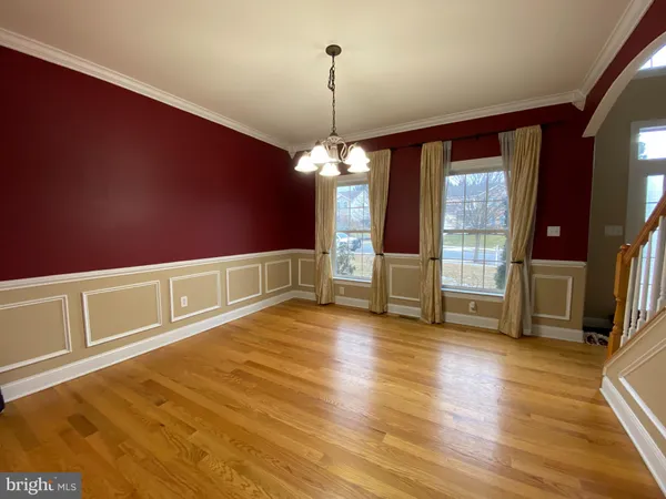 a view of a livingroom with wooden floor and a window