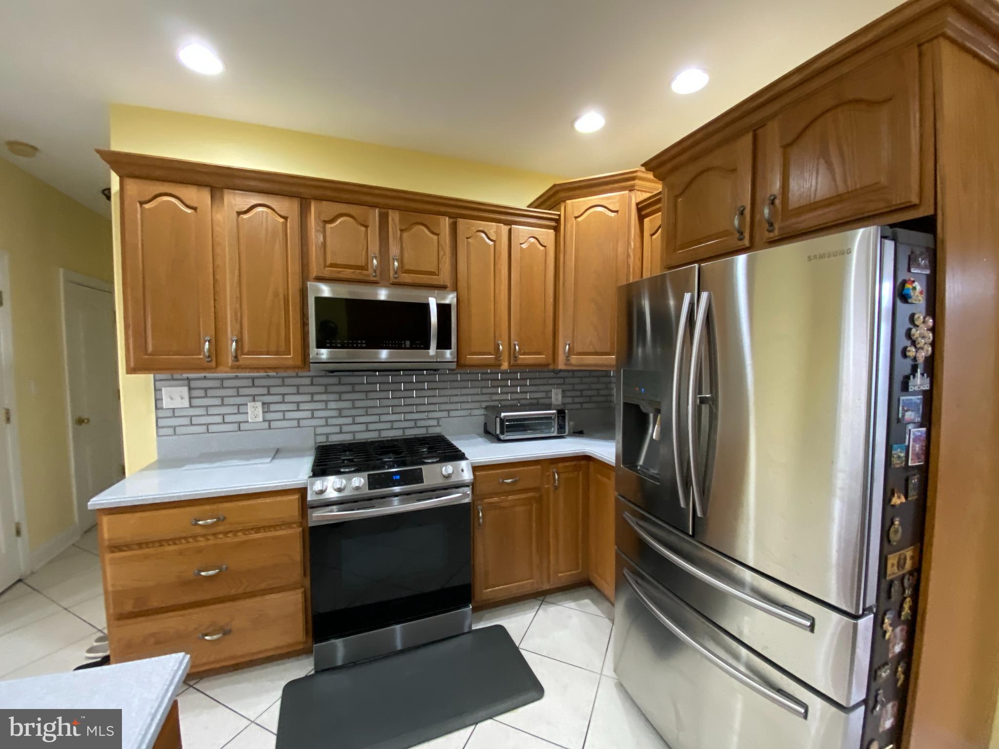 145 Long View Carlisle, PA 17013 - Photo 7 of 27 a kitchen with granite countertop a refrigerator stove and microwave