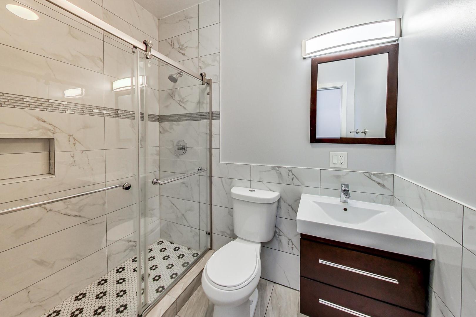 2325 West Taylor Street, Unit 2 Chicago, IL 60612 - Photo 12 of 19 a bathroom with a sink a toilet and shower