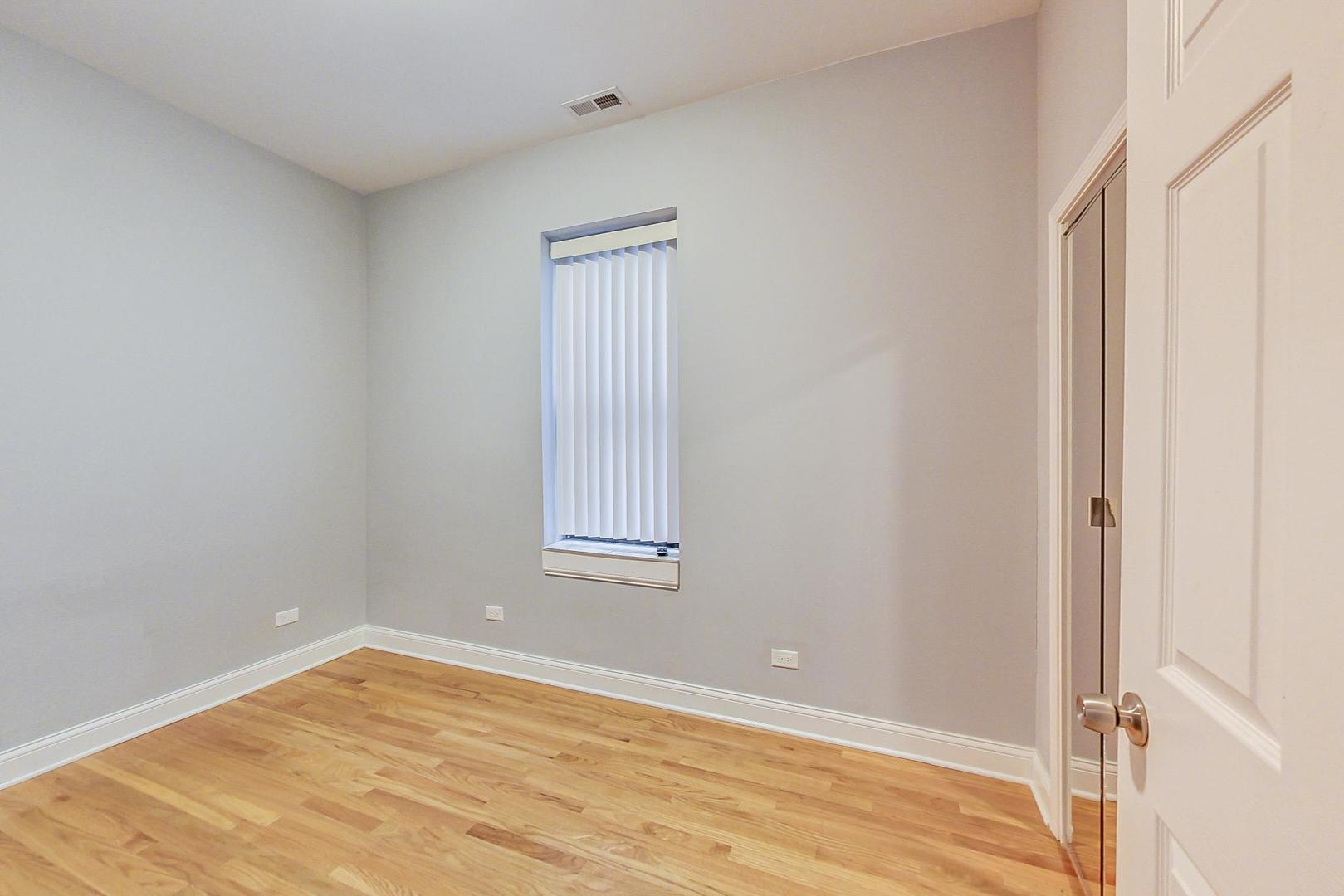 2325 West Taylor Street, Unit 2 Chicago, IL 60612 - Photo 13 of 19 a view of an empty room with wooden floor and a window