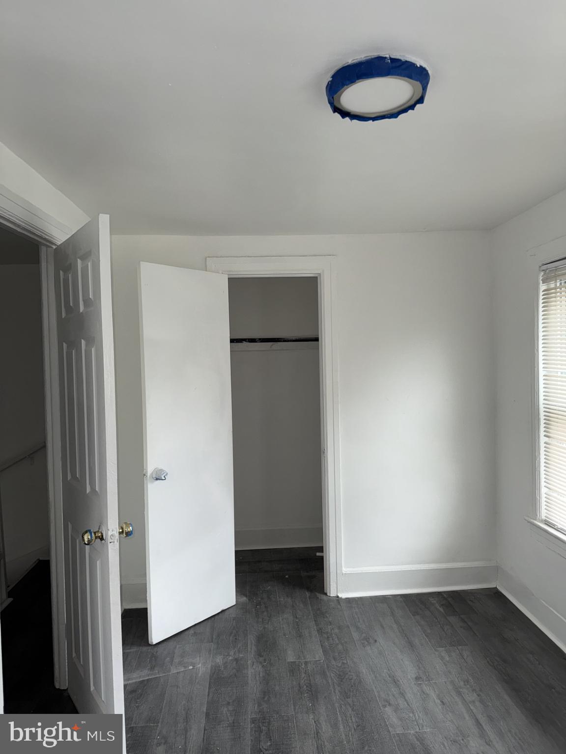 536 Keystone Avenue Darby, PA 19023 - Photo 8 of 11 an empty room with wooden floor and windows