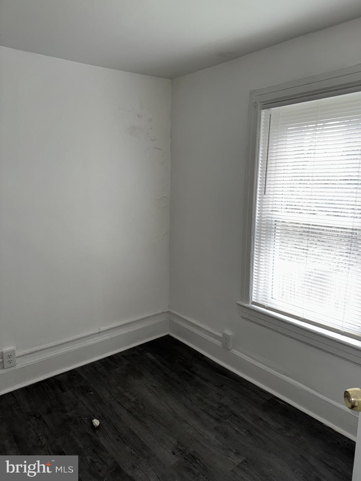 536 Keystone Avenue Darby, PA 19023 - Photo 10 of 11 a view of an empty room with wooden floor and a window