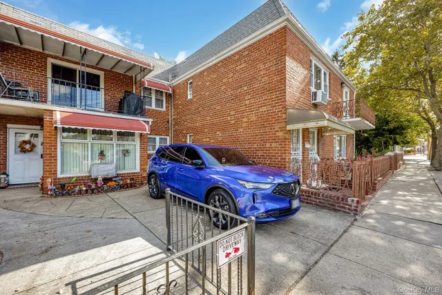 a red car parked in front of a building