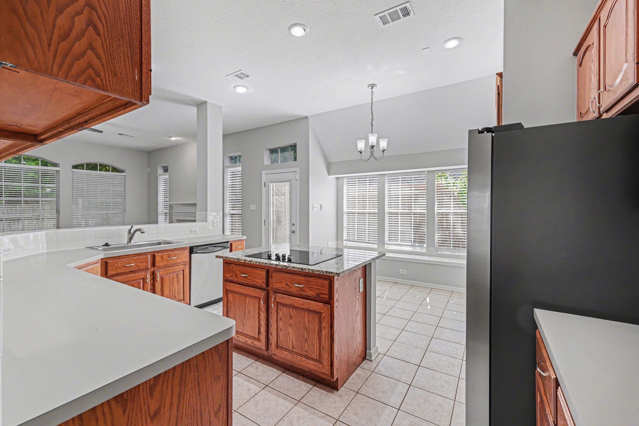 215 Bristol Bend Circle Spring, TX 77382 - Photo 7 of 25 a kitchen with stainless steel appliances granite countertop a sink a counter space and cabinets