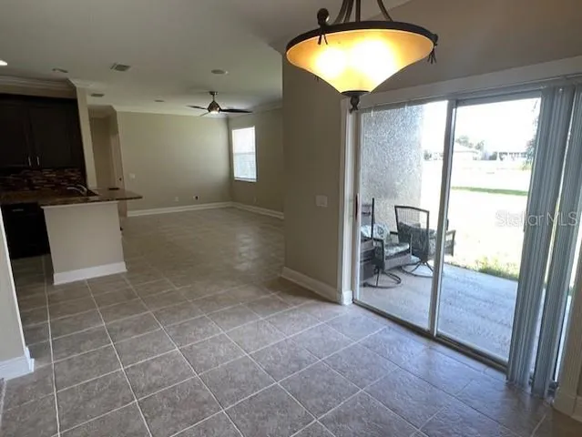 a view of a livingroom with kitchen and furniture