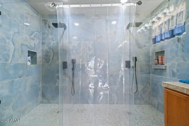 a bathroom with a glass shower door