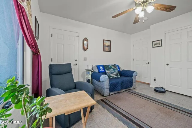 a living room with furniture and a potted plant