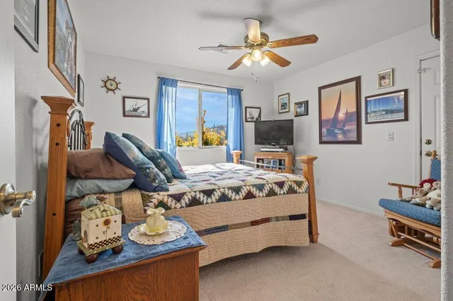 a bedroom with bed and wooden floor