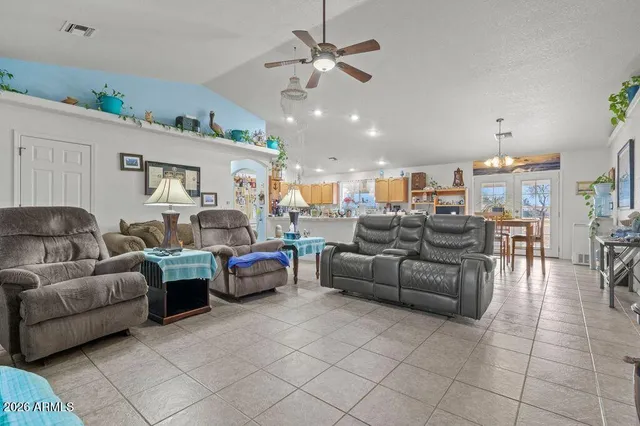 a living room with furniture and a view of kitchen