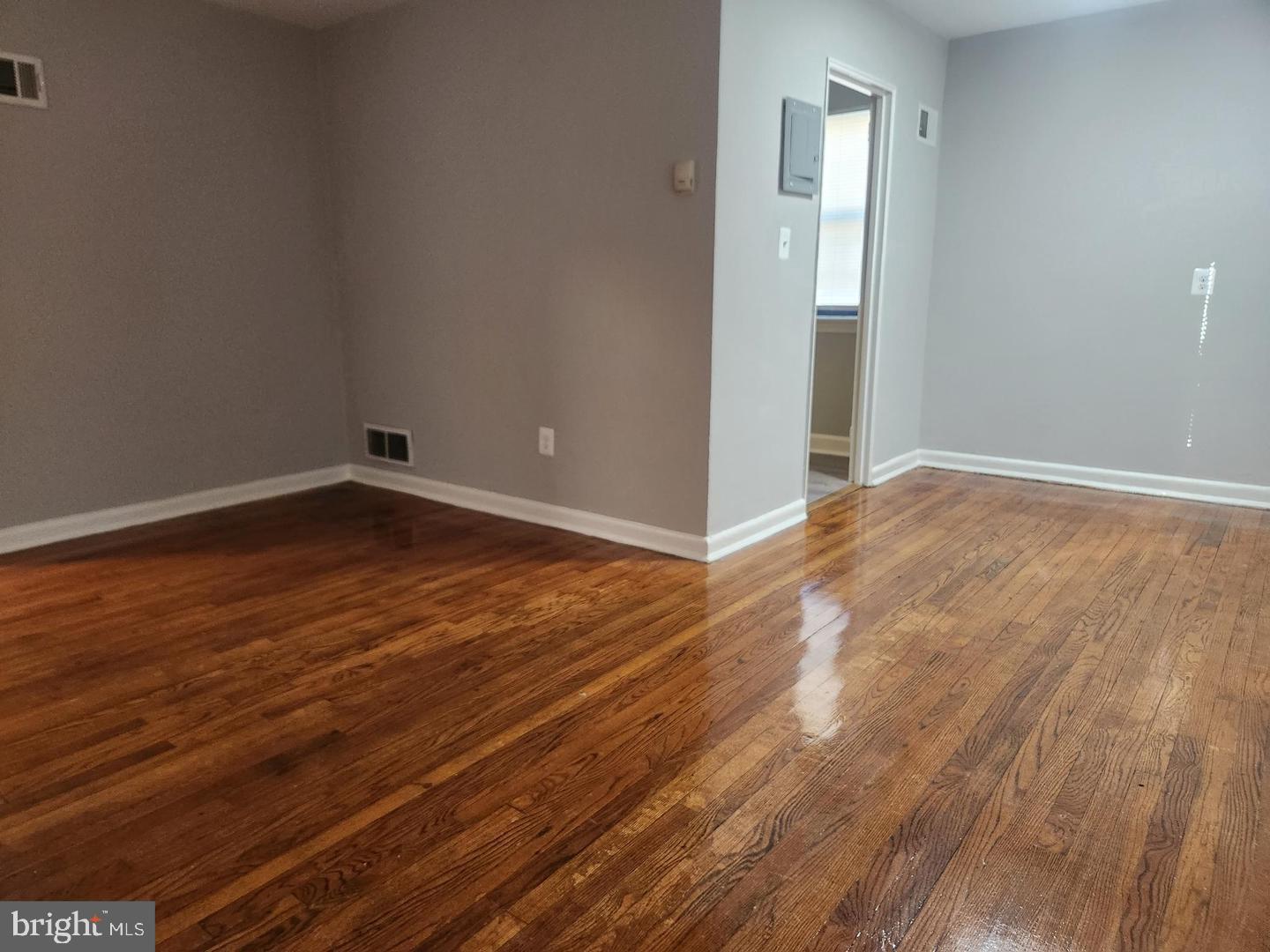1126 48th Place Northeast Washington, DC 20019 - Photo 12 of 14 a view of an empty room with wooden floor and a window