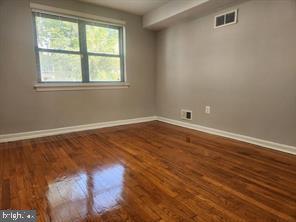 1126 48th Place Northeast Washington, DC 20019 - Photo 5 of 14 an empty room with wooden floor and windows
