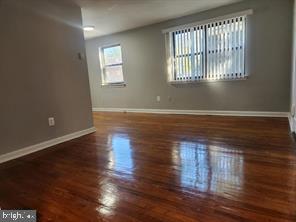 1126 48th Place Northeast Washington, DC 20019 - Photo 7 of 14 an empty room with wooden floor and windows
