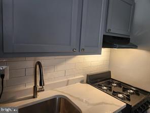 1126 48th Place Northeast Washington, DC 20019 - Photo 10 of 14 a kitchen with a sink a stove and cabinets