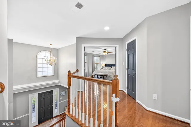 a bathroom with double vanity sinks a large mirror and a bathtub