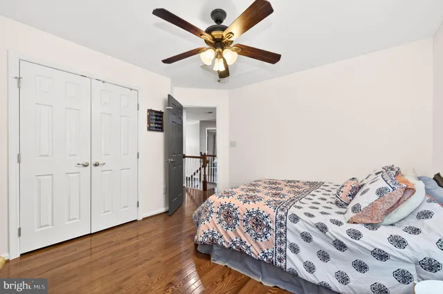 a reading room with wooden floor and furniture