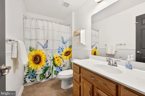 a bathroom with a sink mirror and toilet