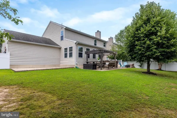 a house view with swimming pool and garden space