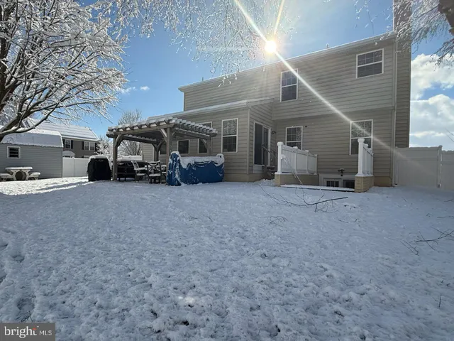 a front view of a house with a tree