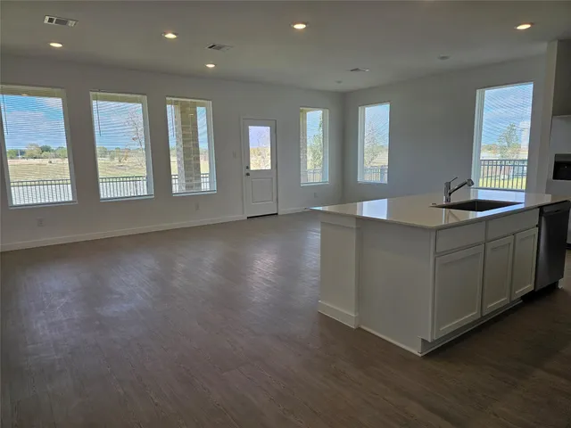 a view of kitchen with windows and cabinet