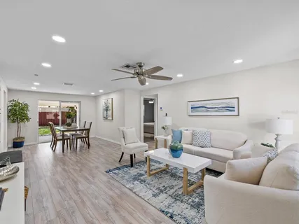 a living room with furniture and a wooden floor
