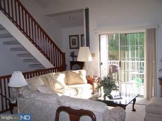 504 B Wharton Road, Unit B Mount Laurel, NJ 08054 - Photo 2 of 6 a living room with couches chandelier and a dining table with wooden floor