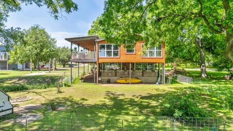 a view of a house with a yard patio and swimming pool