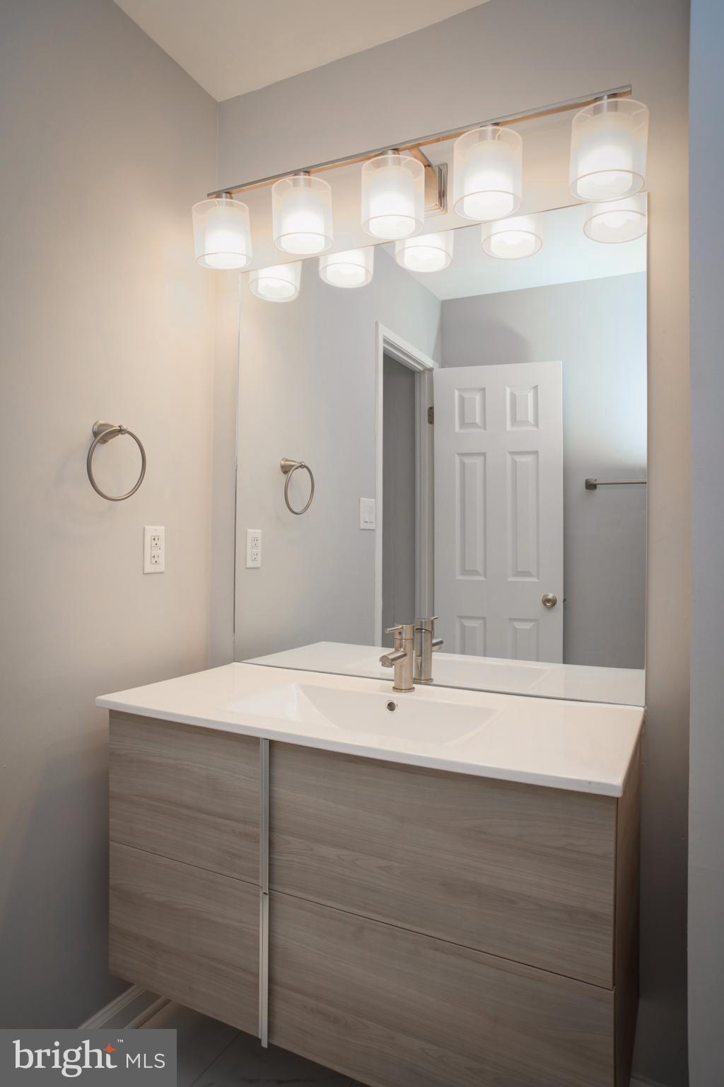 11616 Ivystone Court, Unit 301 Reston, VA 20191 - Photo 22 of 29 a bathroom with a sink a vanity and a mirror