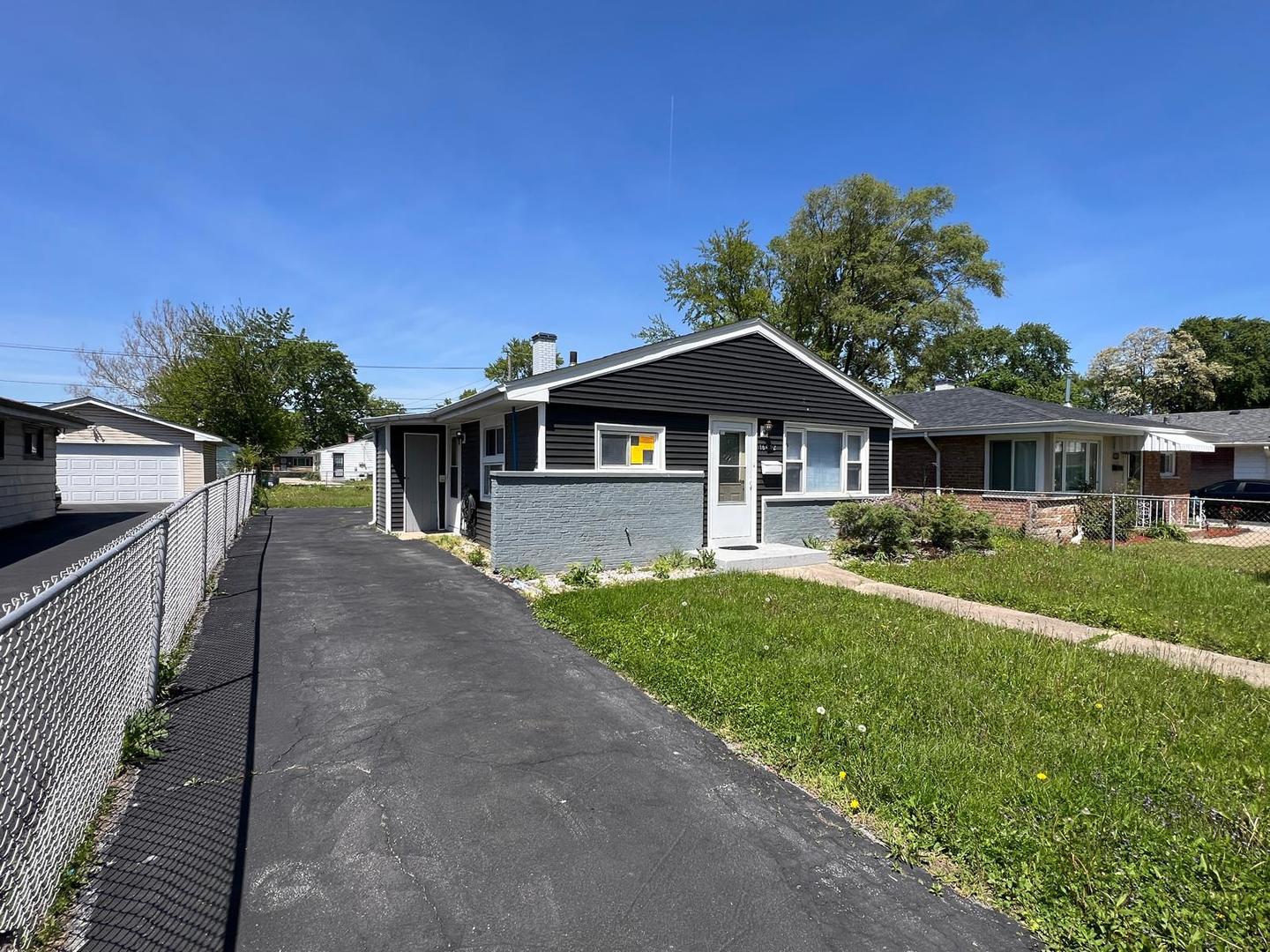 16442 Honore Avenue Markham, IL 60428 - Photo 16 of 16 a front view of a house with a yard