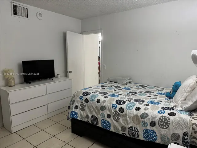 a bedroom with a bed and a television in it