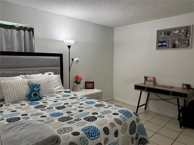 a bedroom with a bed a desk and chair