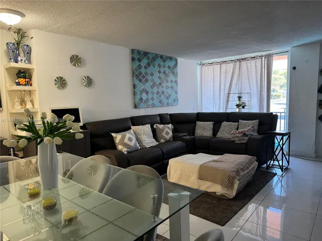 a living room with furniture and painting on the wall