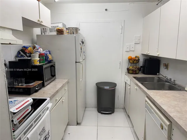 a kitchen with a sink and refrigerator