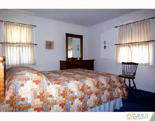 185 South Hill Road Colonia, NJ 07067 - Photo 5 of 10 a bedroom with a bed window and table