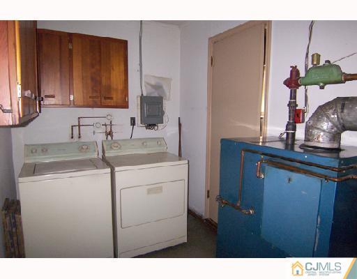 185 South Hill Road Colonia, NJ 07067 - Photo 8 of 10 a bathroom with a sink and a mirror