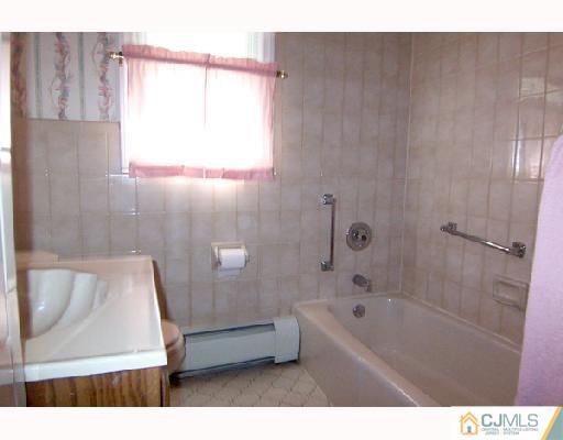 185 South Hill Road Colonia, NJ 07067 - Photo 9 of 10 a bathroom with a bathtub and a shower