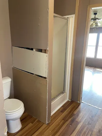 a bathroom with a toilet and a shower