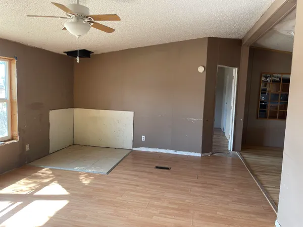 a view of an empty room with closet and a window