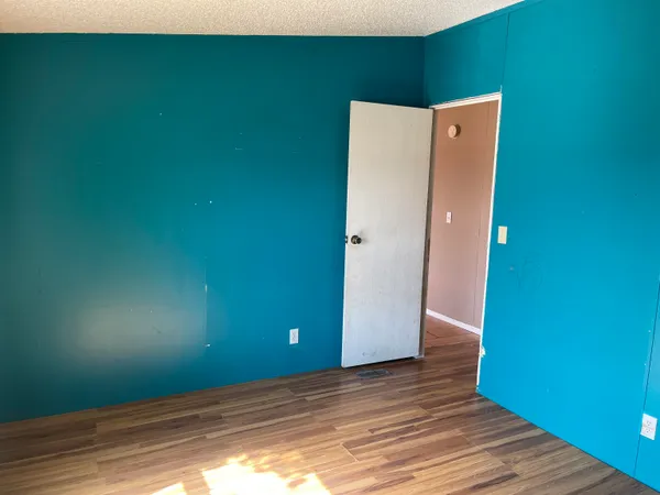 a view of a room with wooden floor