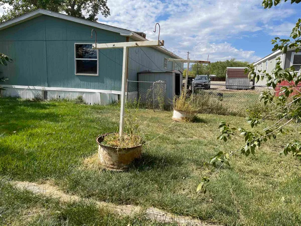 a backyard of a house with fountain table and chairs