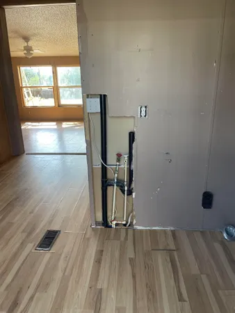 an empty room with wooden floor and a window