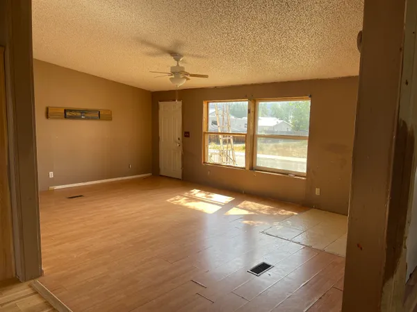 an empty room with windows and entrance