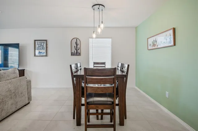 a dining room with furniture and window