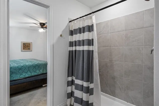 a bathroom with a shower and a sink