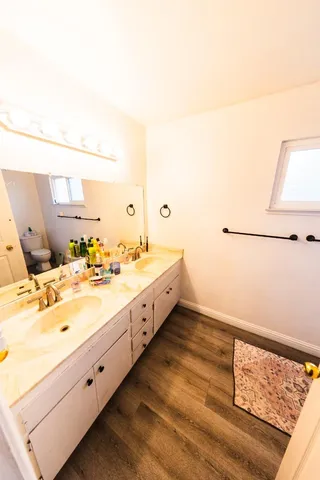 a spacious bathroom with a double vanity sink and a mirror