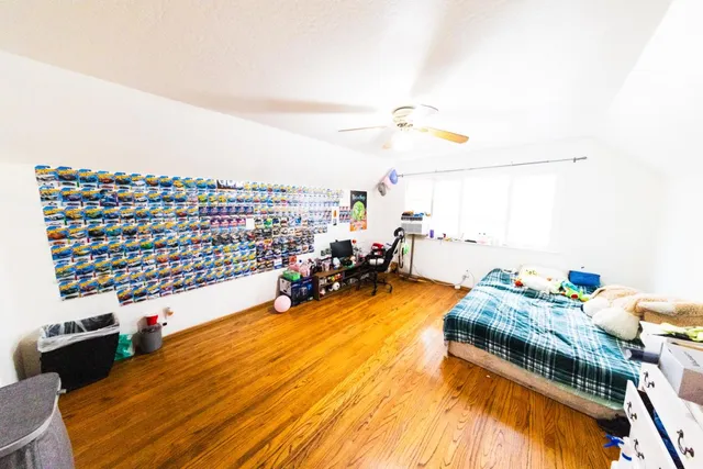 a bedroom with furniture and a book shelf